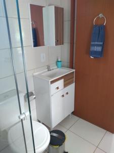 a bathroom with a toilet and a sink and a shower at Recanto Marina in Guarda do Embaú +21 photos