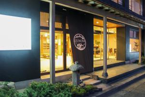 a restaurant with a sign on the side of a building at HOTEL&RESORT Izu no Ne in Higashiizu