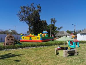 a park with a playground with a inflatable bounce house at Casa Flores Hotel & Spa in Atlixco