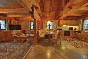 a dining room with a table and a kitchen at Glocknerhaus in Berg im Drautal