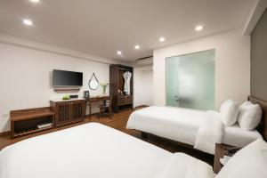 Voodi või voodid majutusasutuse Hanoi Exclusive Hotel toas