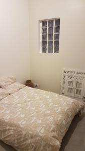 ein weißes Schlafzimmer mit einem Bett in einem Zimmer in der Unterkunft Appartement au calme in Changis-sur-Marne