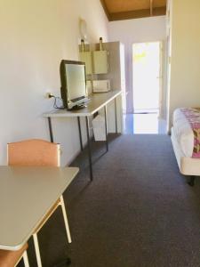 a living room with a desk and a chair at Bakery Park Motor Inn in Tocumwal