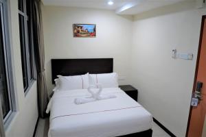 Postel nebo postele na pokoji v ubytování DCozy Hotel