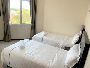 Postel nebo postele na pokoji v ubytování DCozy Hotel