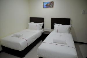 Postel nebo postele na pokoji v ubytování DCozy Hotel