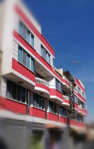 a red and white building on a street at Residencial Mariloy in Cochabamba