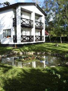 una casa con un estanque delante de ella en Tuule Villa, en Kuressaare