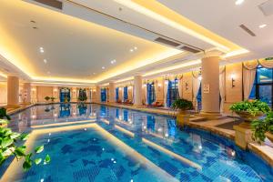 a large swimming pool in a hotel lobby at Your World International Conference Centre in Yiwu