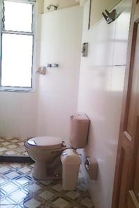 a bathroom with a toilet and a window at Residencial Mariloy in Cochabamba