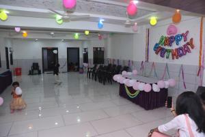 a room with a table and chairs and balloons at Hotel Dwarawati in Dwarka