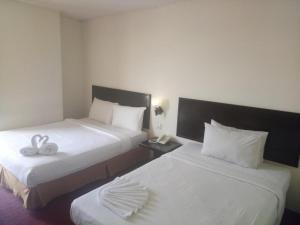 Postel nebo postele na pokoji v ubytování Hotel Sri Sutra PJ 222