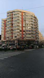 a large apartment building on a city street at Clucerului Sun Residence Villa in Bucharest