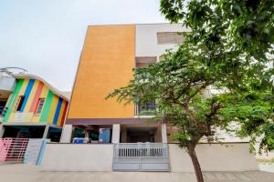a building with a tree in front of it at Aster Suites in Bangalore