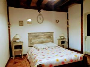 a bedroom with a bed and two night stands at Ker Carlines in Targassonne