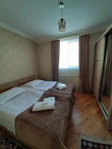 A bed or beds in a room at Kazbegi Guide