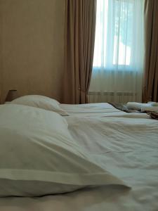 A bed or beds in a room at Kazbegi Guide
