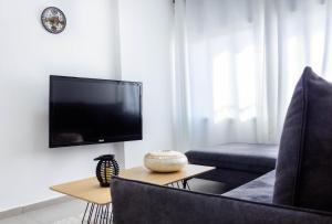 a living room with a tv and a couch at Cosy & Modern old city 3BR by Ahlan Hospitality in Nazareth