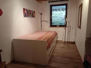 a bedroom with a bed and a window at Ferienwohnung Schmallenberg in Schmallenberg