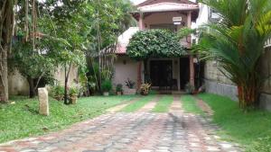 a house with a brick walkway in front of it at SA Village in Dambulla