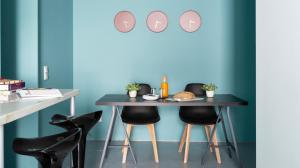 a table with black chairs and a blue wall at ALTIDO Stylish 5BR Apt with big terrace in Principe Real in Lisbon