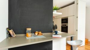 a desk with a black chalkboard in a kitchen at ALTIDO Stylish 5BR Apt with big terrace in Principe Real in Lisbon
