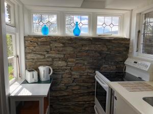 a kitchen with blue vases on the wall at Dalton's Deed in Roxburgh