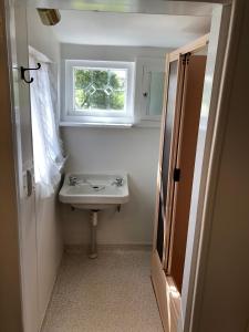 a bathroom with a sink and a window at Dalton's Deed in Roxburgh