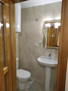 a bathroom with a sink and a toilet and a mirror at Катерина in Rozhanka Nizhnyaya