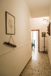 a hallway with a white wall with a picture on it at Villa Carmela Capotosto in Mondragone +9 photos