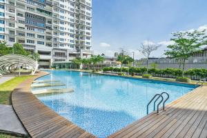 a large swimming pool in front of a building at Puchong Skypod Residence, 1-5 pax with Balcony Unit, Walking Distance to IOI Mall, 10min Drive to Sunway in Puchong