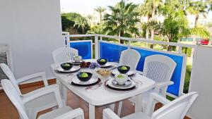 a white table and chairs on a balcony at PALMERAS EN LA PLAYA - Beach House in Oliva in Oliva