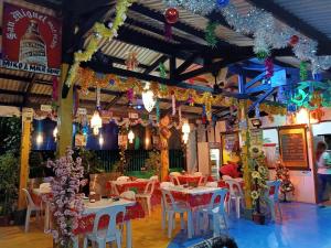 a restaurant with tables and chairs and christmas decorations at Moalboal Bamboo Guest House in Moalboal