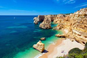 a view of a beach with rocks in the ocean at Sun and Beach I AC+Wifi+Close to the Beach in Portimão