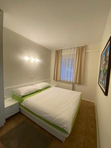 a bedroom with a large white bed and a window at Apartments Villa BEAUTY PORTOROŽ in Portorož +97 photos