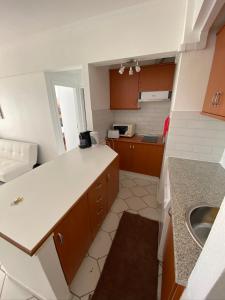 a small kitchen with a counter and a sink at Apartamento Atlantico - Vista Mar in Monte Gordo
