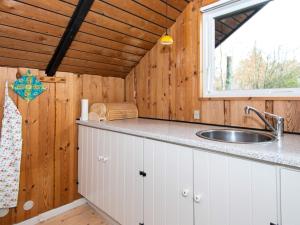 a kitchen with a sink and a window at 6 person holiday home in Fårvang in Fårvang +20 photos