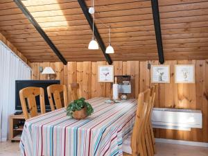 a dining room with a table with a pineapple on it at 6 person holiday home in Fårvang in Fårvang