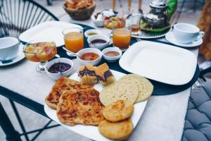 a table with a plate of food with bread and drinks at Riad Bamboo Suites & Spa in Marrakech