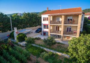 an aerial view of a house with a yard at Apartments Anita 1 in Barbat na Rabu