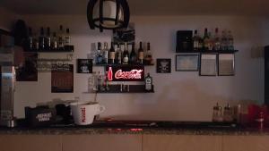 a bar with a coca cola sign on the wall at Vila Dora in Costinesti