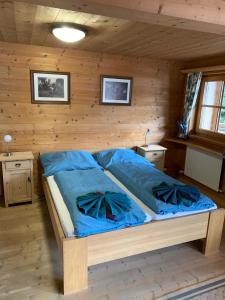 a bedroom with a bed in a wooden room at Landhaus Erlzette in Tux