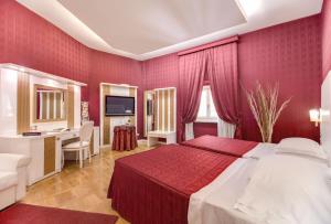 a hotel room with a bed and a desk at Relais Fontana Di Trevi Hotel in Rome