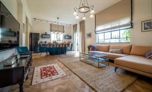 a living room with a couch and a table at VELLER Yehuda Halevi in Tel Aviv