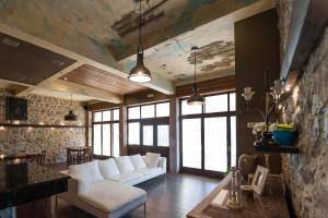 a living room with a white couch and some windows at Polys Guest House in Katachás