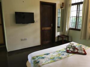 Кровать или кровати в номере Bristol Cottages Kilimanjaro