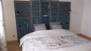 Ce lit se trouve dans un dortoir doté d'un mur en bois. dans l'établissement Le Jardinet, à Pont-Sainte-Maxence