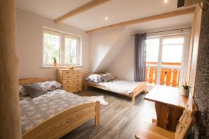 A bed or beds in a room at Noclegi u Gabrysi