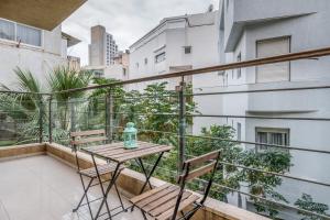 a balcony with two chairs and a table on it at Very nice 1 BDR apartment 2 min from the beach ! in Tel Aviv