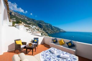 a hotel room with a balcony overlooking the ocean at La Casa di Peppe Guest House & Villa in Positano